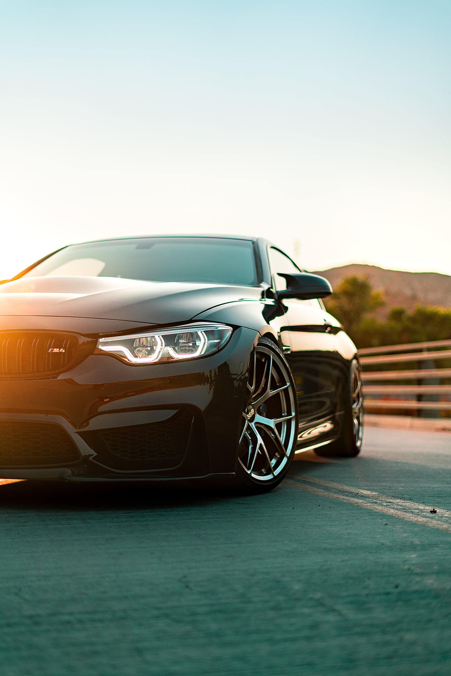 Sleek Black BMW M4 Coupe on a Sunset Road with Custom Alloy Wheels HD phone wallpaper
