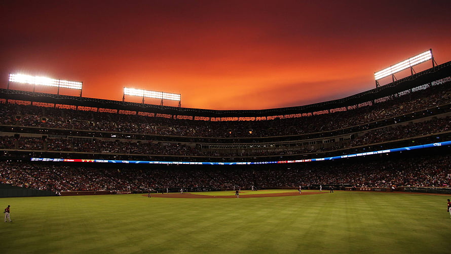 Dramatic Orange Sunset Over a Packed Cricket Stadium at Night HD wallpaper