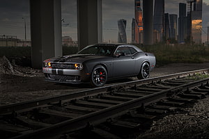Dark Gray Dodge Challenger SRT Hellcat on Urban Railway Tracks at Dusk HD wallpaper