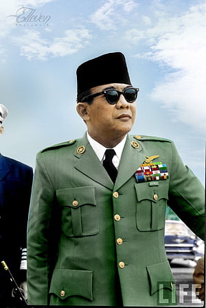 Soekarno in formal military uniform with medals and black cap against a blue sky HD phone wallpaper