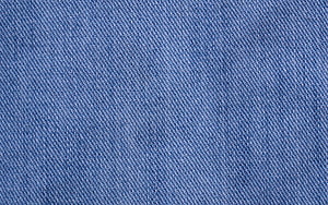 Close-up of blue denim fabric weave showing detailed twill texture and thread pattern HD wallpaper