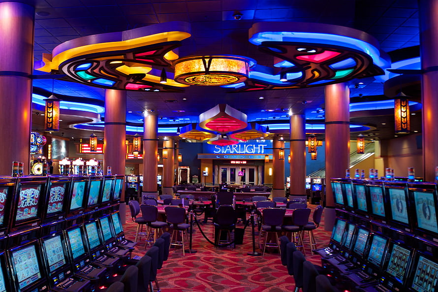 Vibrant Casino Gaming Floor With Slot Machines And Starlight Lounge HD wallpaper