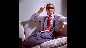 Morpheus from The Matrix wearing sunglasses and red tie sitting on couch HD wallpaper