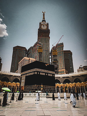 The Kaaba in Mecca with the Abraj Al Bait Clock Tower in the Background HD phone wallpaper