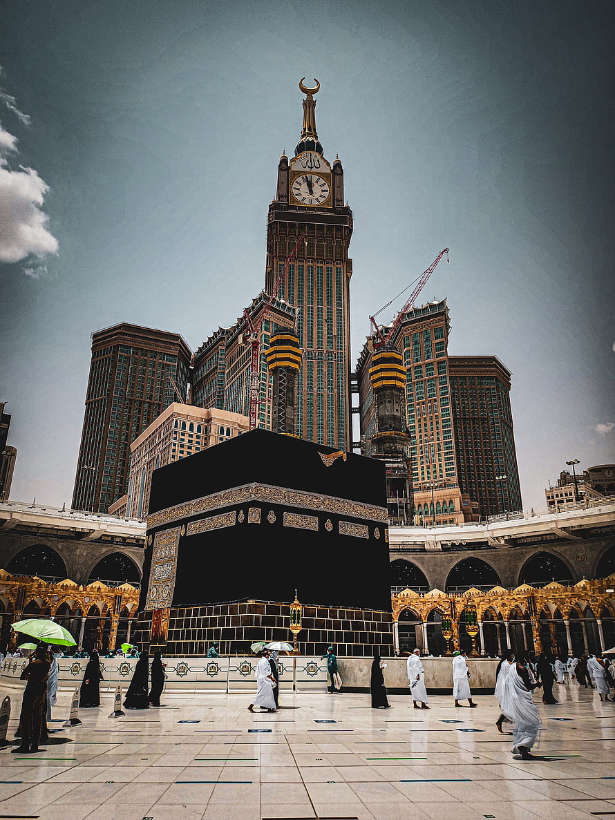 The Kaaba in Mecca with the Abraj Al Bait Clock Tower in the Background HD phone wallpaper