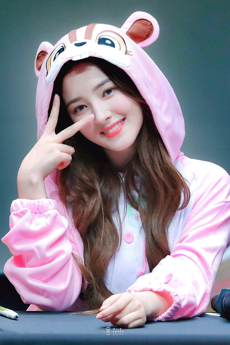 Nancy from Momoland in a pink animal hooded onesie making a peace sign HD phone wallpaper