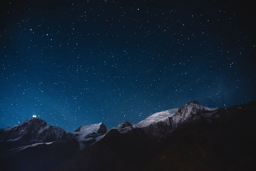 Starry Night Sky Over Snow-Capped Mountain Peaks HD wallpaper