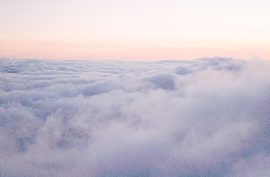 Serene Aerial View of a Soft Cloud Sea Under a Pastel Dawn Sky HD wallpaper