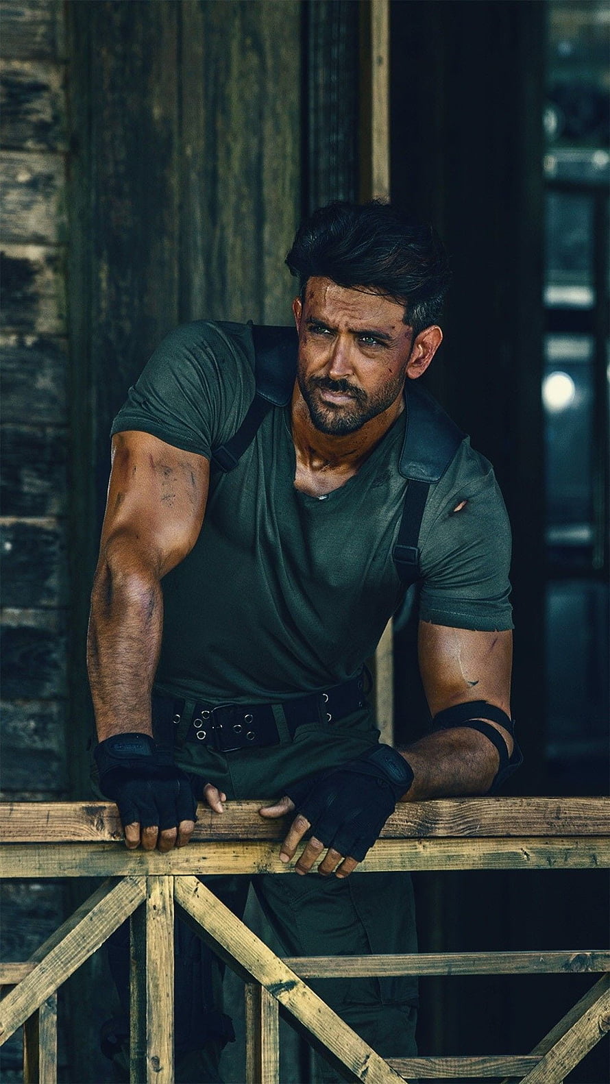 Hrithik Roshan as Kabir Singh in intense military tactical gear leaning on wooden railing HD phone wallpaper