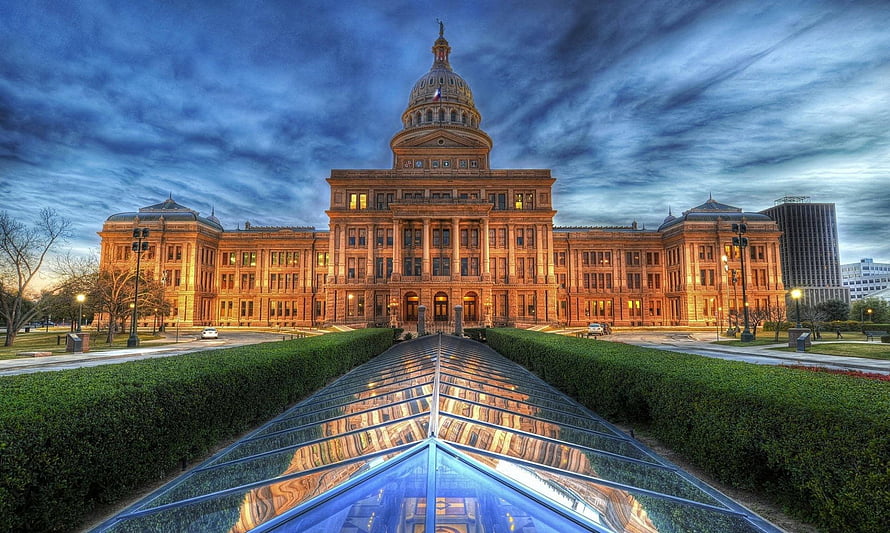 Texas State Capitol Building at Dusk with Reflective Water Feature and Dramatic Sky HD wallpaper