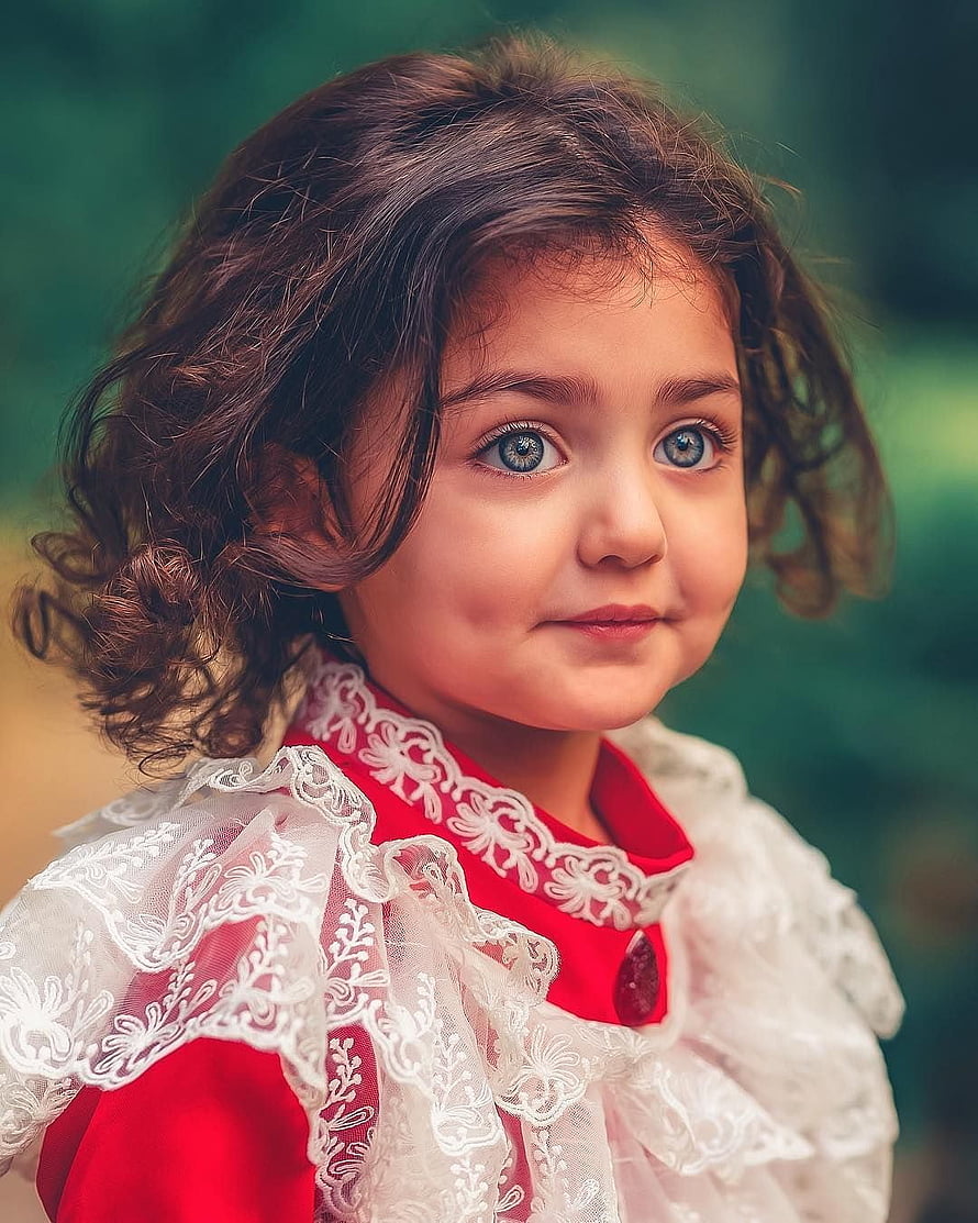 Portrait of a young girl with curly brown hair and blue eyes wearing a red dress with white lace collar HD phone wallpaper