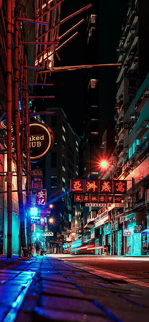 Neon-lit Hong Kong street at night with bamboo scaffolding and glowing signs HD phone wallpaper