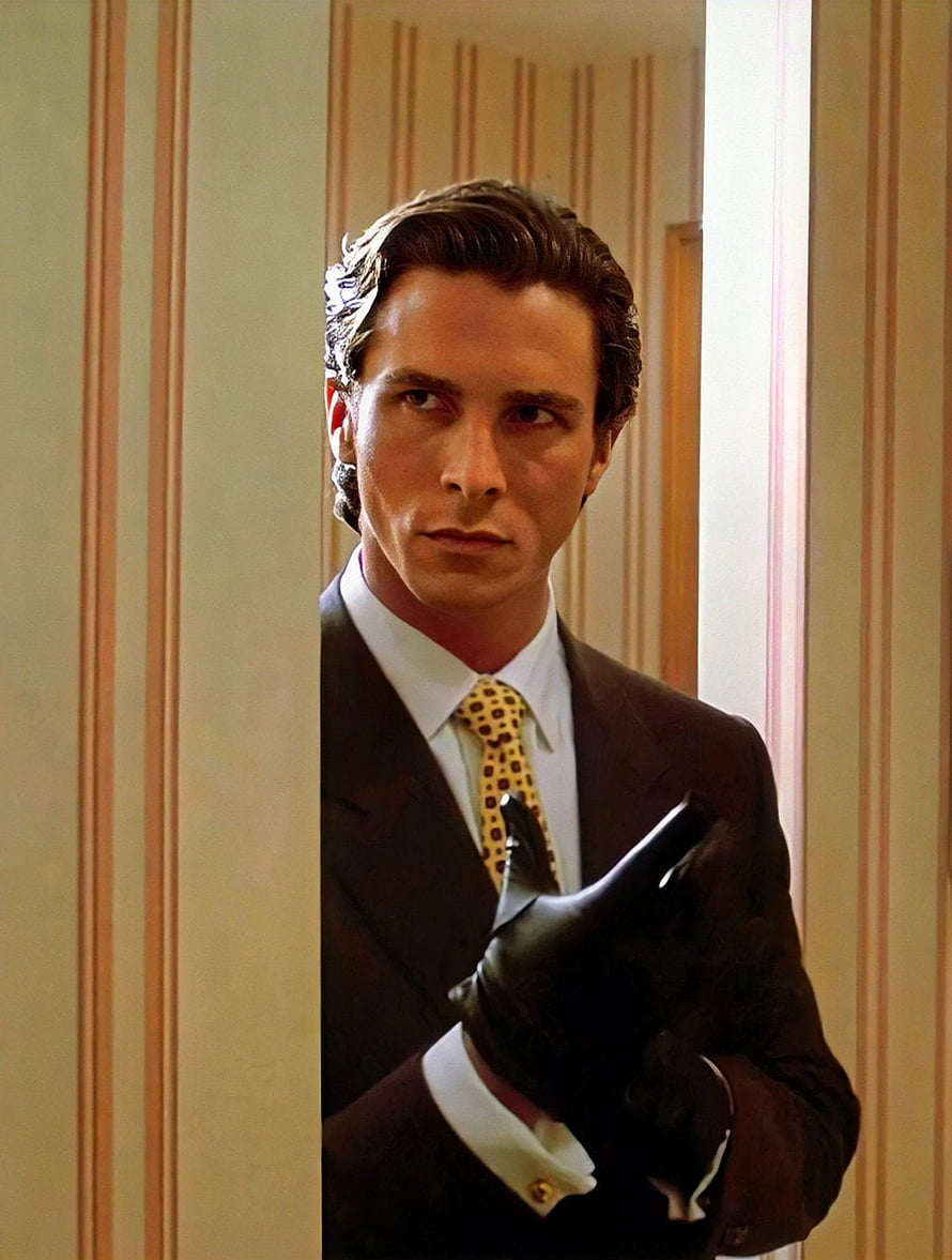 Christian Bale as Patrick Bateman in American Psycho wearing a suit and putting on a leather glove, American psycho, dress_shirt, tie HD phone wallpaper