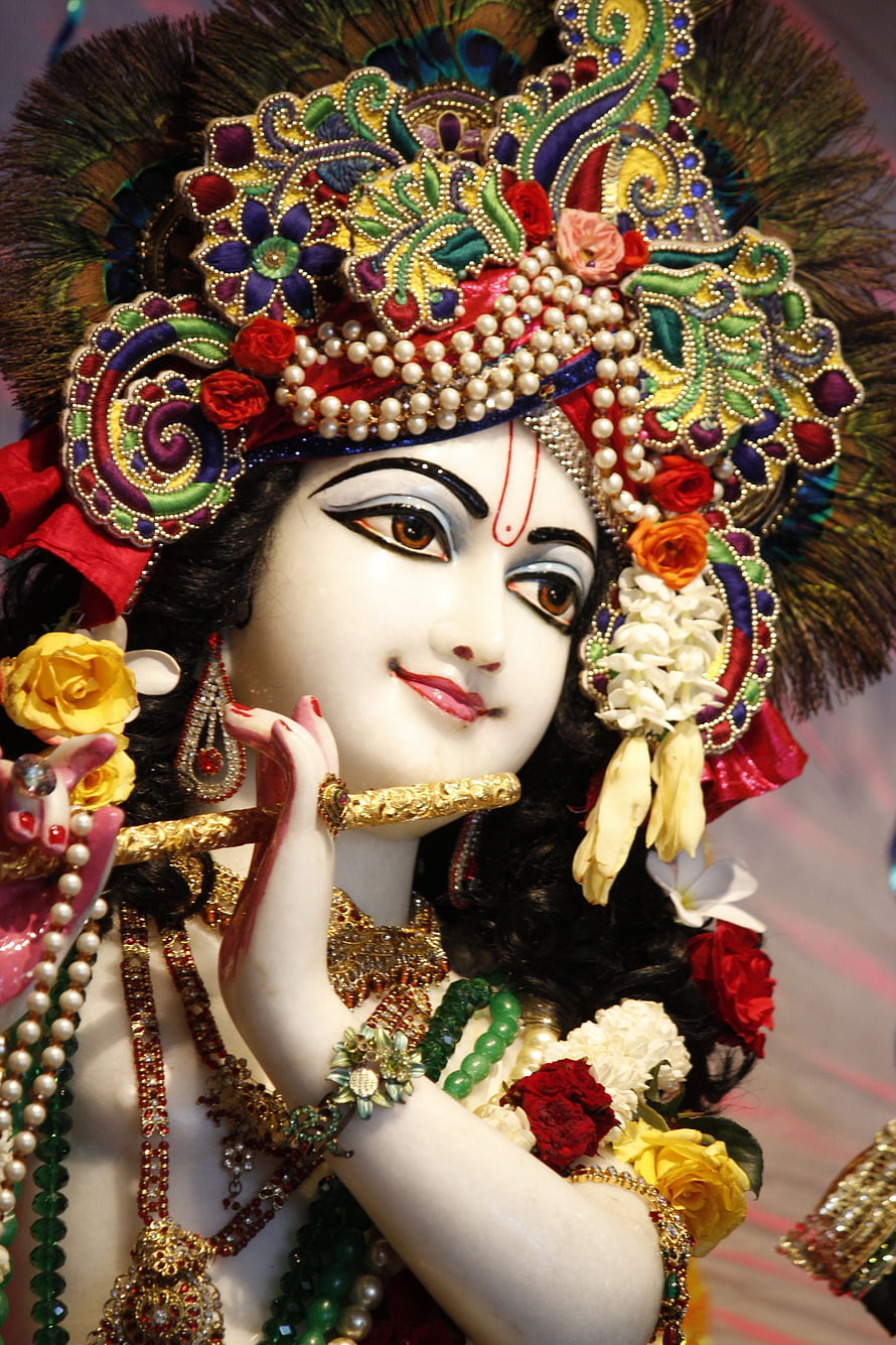 Ornate Sri Krishna Murti with Peacock Crown and Floral Garlands HD phone wallpaper