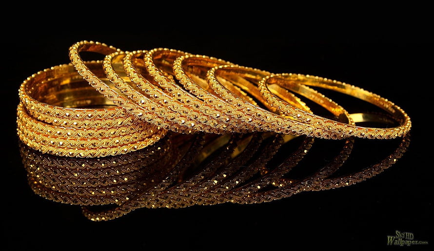 Intricate Gold Bangle Bracelets with Filigree Patterns on Black Background HD wallpaper