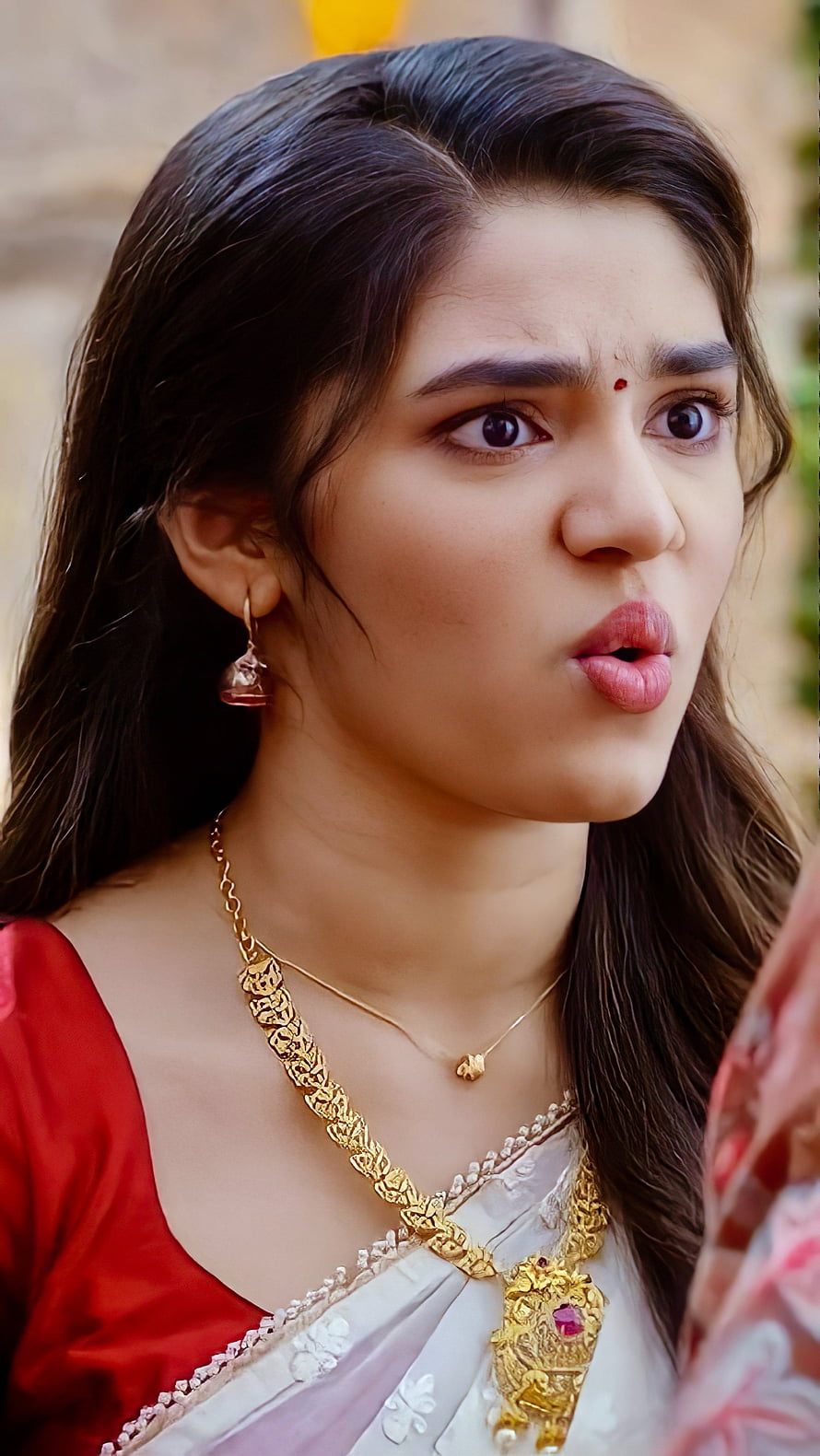 Krithi Shetty in Traditional Red Saree with Gold Jewelry and Expressive Portrait HD phone wallpaper