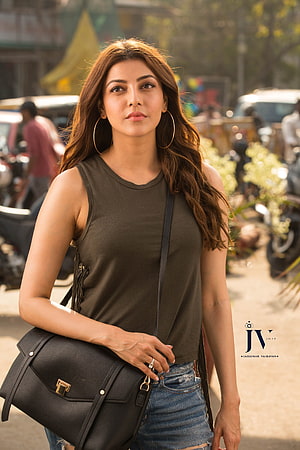 Kajal Aggarwal in Olive Green Top and Denim Skirt with Black Handbag HD phone wallpaper