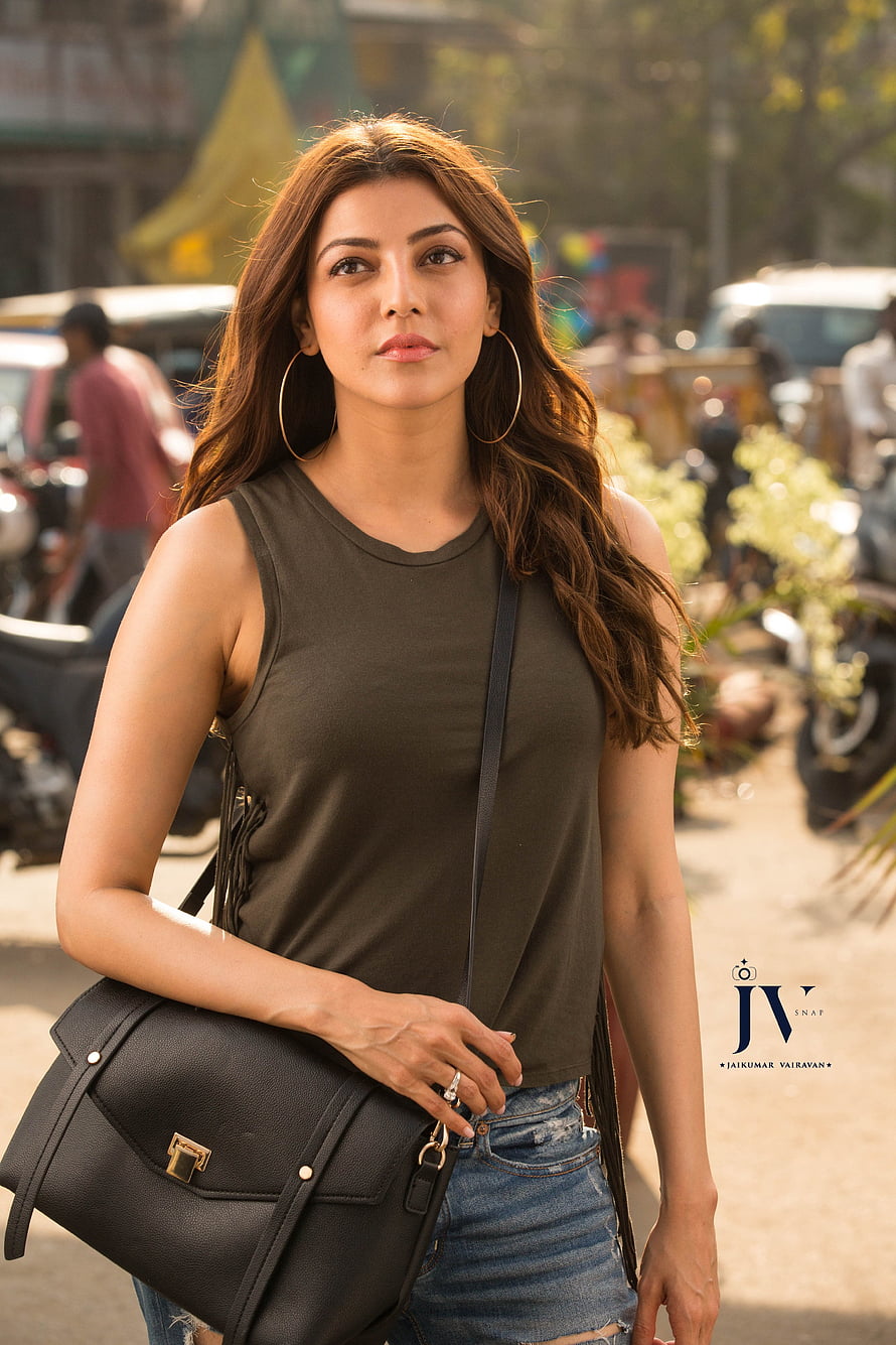 Kajal Aggarwal in Olive Green Top and Denim Skirt with Black Handbag HD phone wallpaper