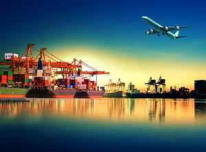 Container Ship and Airplane at a Busy Port During Golden Hour Sunset HD wallpaper