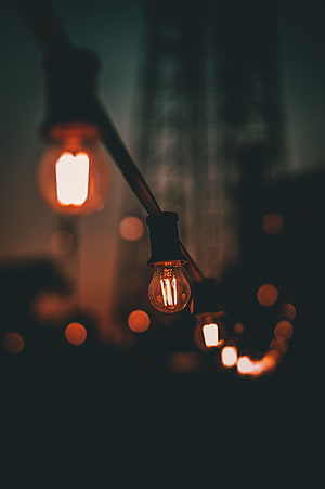 Warm Edison Bulb String Lights Against Dark Moody Background HD phone wallpaper
