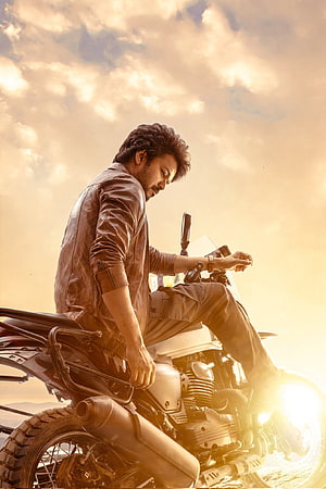 Vijay on a motorcycle in a golden sunset sky from the movie Varisu HD phone wallpaper