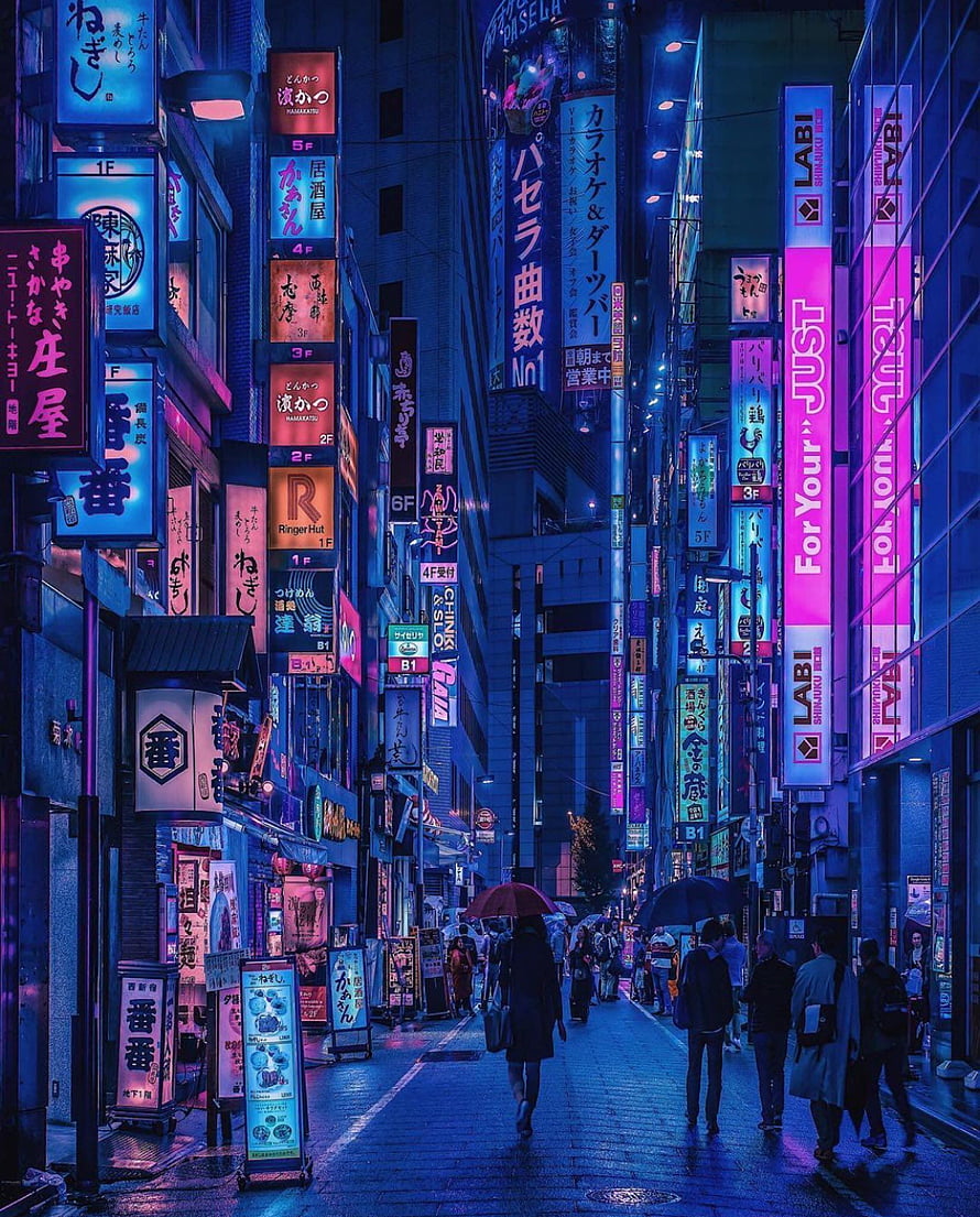 Neon-lit Tokyo street at night with glowing signs and pedestrians walking under umbrellas in the rain HD phone wallpaper
