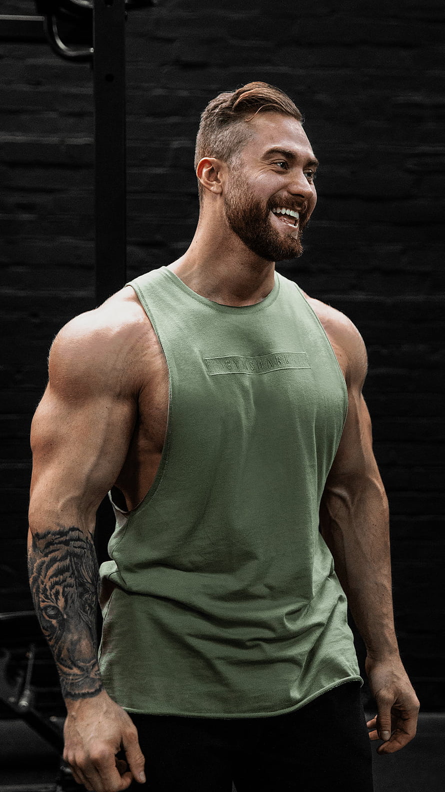 Chris Bumstead in Green Gym Tank Top with Tiger Arm Tattoo in Dark Studio HD phone wallpaper