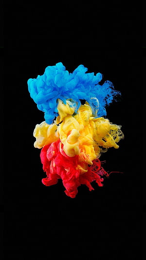 Vibrant Blue Yellow and Red Ink Clouds Swirling in Water on Black Background HD phone wallpaper