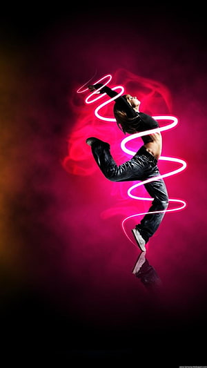 Female Dancer in Dynamic Pose with Neon Light Trails Against Smoky Pink Background HD phone wallpaper