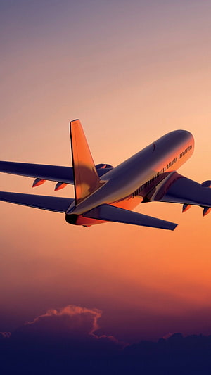 Commercial Jetliner Cruising Through Golden Sunset Sky With Dramatic Clouds HD phone wallpaper