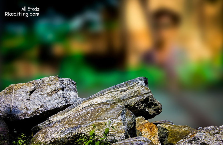 Close-Up of Textured Grey Rocks with Blurred Green Background HD wallpaper