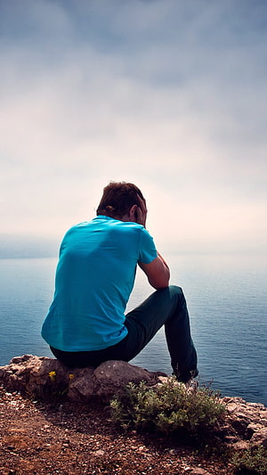 Man Sitting Alone on Rocky Cliff Overlooking the Sea in a Moment of Solitude, Single Boy Attitude, Sad, Alone HD phone wallpaper