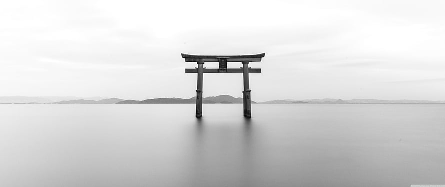 Monochrome Torii Gate Standing in Calm Water with Distant Hills HD wallpaper