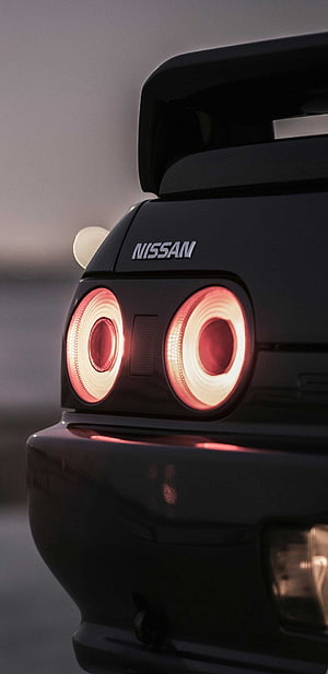 Nissan Skyline R32 Rear Taillight Close-Up with Glowing Red Rings and Spoiler HD phone wallpaper