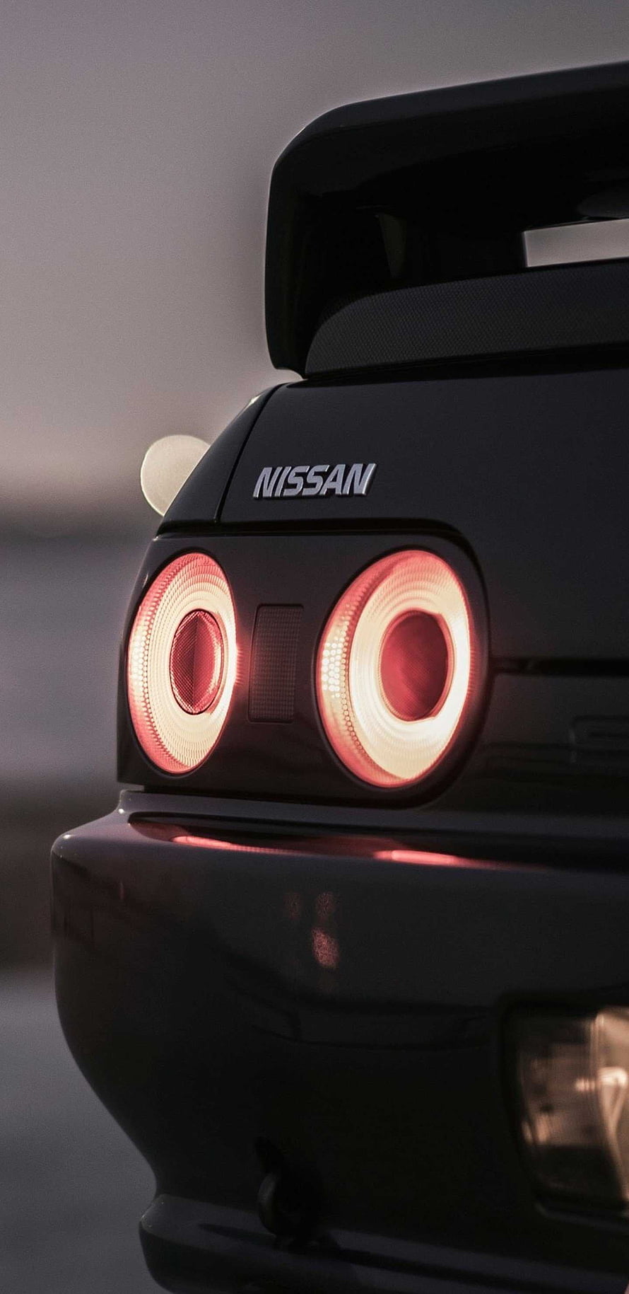 Nissan Skyline R32 Rear Taillight Close-Up with Glowing Red Rings and Spoiler HD phone wallpaper