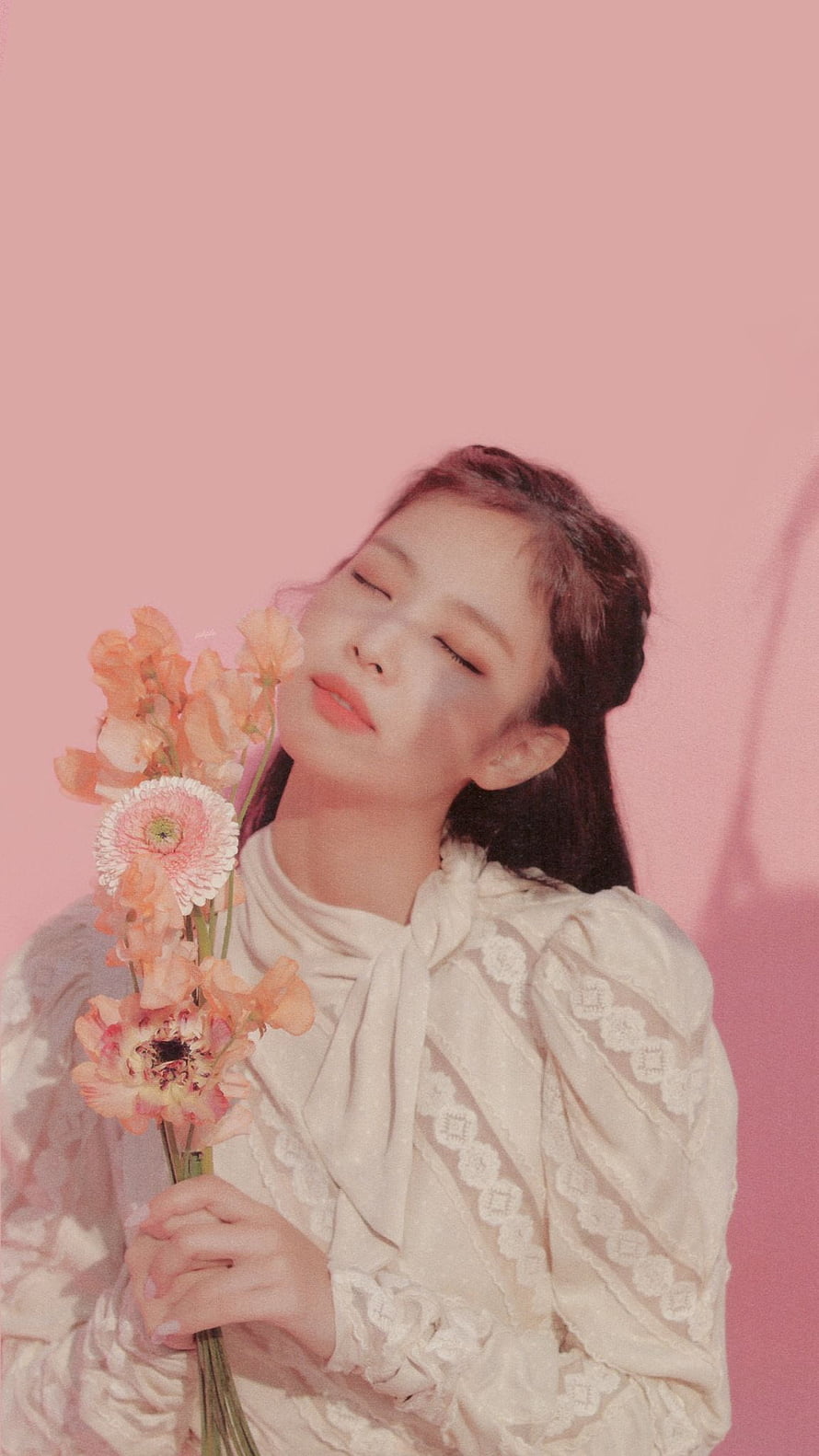 Jennie Kim holding flowers with eyes closed in a white lace blouse against a pink background HD phone wallpaper