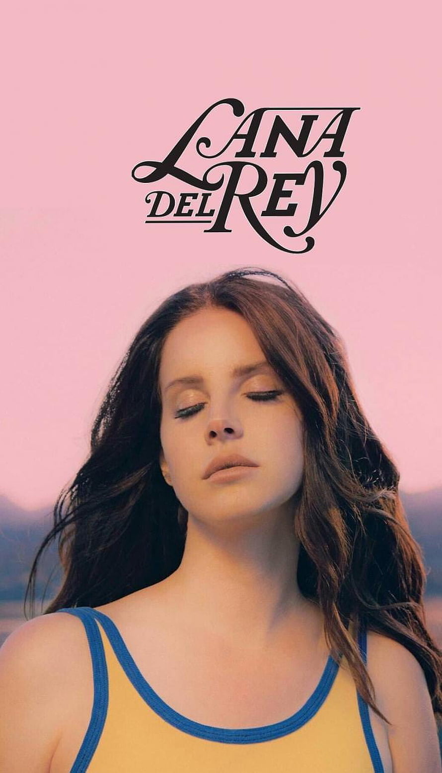 Lana Del Rey Portrait Against Soft Pink Sky With Flowing Hair and Yellow Top HD phone wallpaper