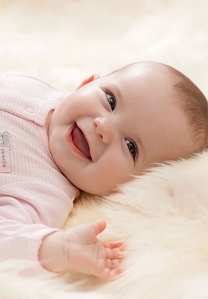Happy Baby Girl Smiling in Pink Onesie on White Fur HD phone wallpaper
