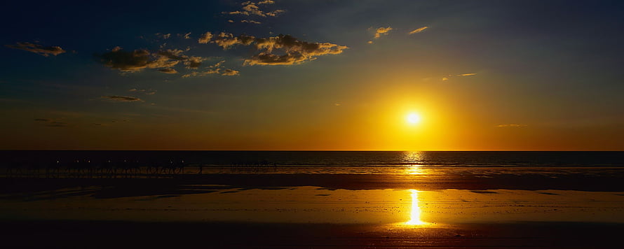 Golden Sunset Over a Wide Beach with Sun Reflection on Wet Sand HD wallpaper