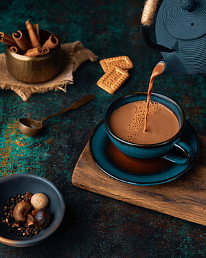 Masala Chai Pouring Into Ceramic Cup With Spices And Biscuits HD phone wallpaper