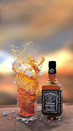 Jack Daniel's Tennessee Whiskey Bottle with Dramatic Amber Liquid Splash and Ice Cubes on Wooden Surface HD phone wallpaper