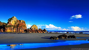 Stunning Coastal Landscape with Dramatic Rock Formations and Blue Sky HD wallpaper