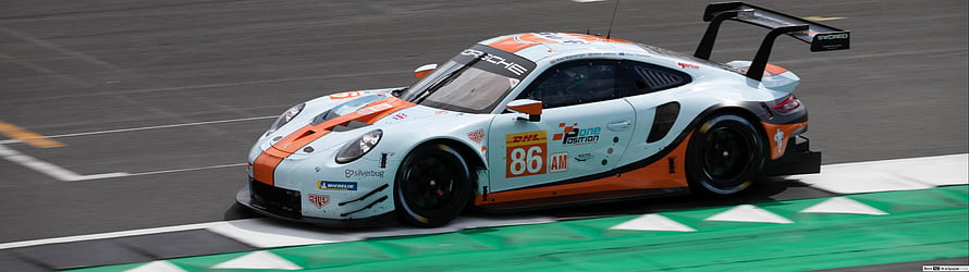 Porsche 911 GT3 R race car in white and orange livery on a motorsport circuit HD wallpaper