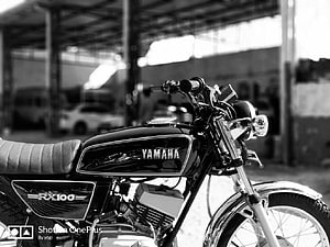 Classic Yamaha RX100 Motorcycle in Black and White Studio Setting HD wallpaper