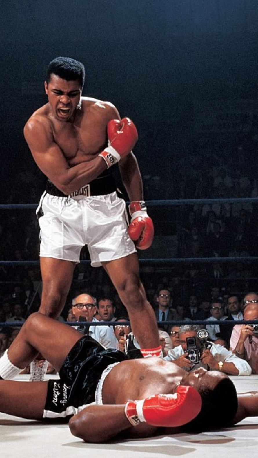 Muhammad Ali Standing Over Knocked Out Opponent in Historic Boxing Match HD phone wallpaper