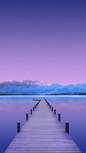 Serene Wooden Pier Extending Into Calm Lake With Snow-Capped Mountains Under a Purple Twilight Sky HD phone wallpaper