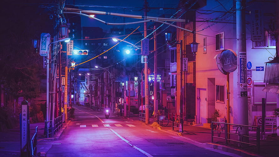Neon-lit Japanese street at night with purple and blue tones, traffic lights, and a lone scooter HD wallpaper