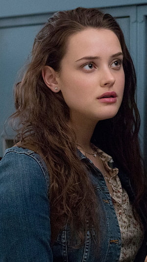 Katherine Langford in denim jacket and floral top looking away with wavy brown hair HD phone wallpaper