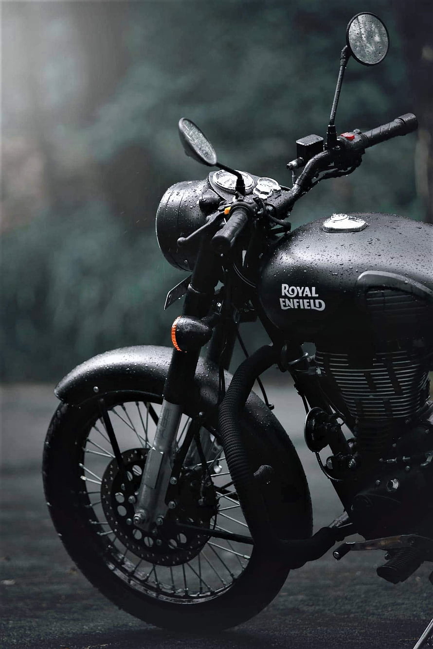 Black Royal Enfield Classic Motorcycle in Rainy Forest Setting HD phone wallpaper