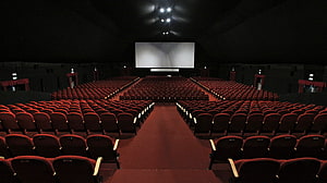 Empty Movie Theater With Red Seats And Large Screen HD wallpaper